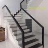 Cầu thang kính không trụ sơn đen đi trên mặt kính
